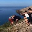 He's on the edge! Moment a fight breaks out at Brazil's famous 'cliff-hanging' selfie spot after one man's photo gets spoiled