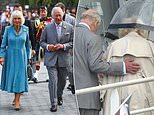 Sweet moment Charles affectionately puts his hand on Camilla's back as he helps her disembark plane in Bordeaux