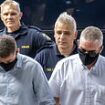 Three British 'drug smugglers from gang responsible for 10% of cocaine shipped into Europe' are led into Greek court for trial under heavy security - as global manhunt continues for leader dubbed 'UK's Pablo Escobar'