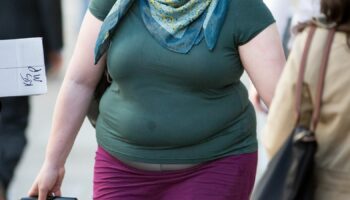 A woman suffering obesity walks in central London. 23rd April 2015. Daniel Leal-Olivas/PA