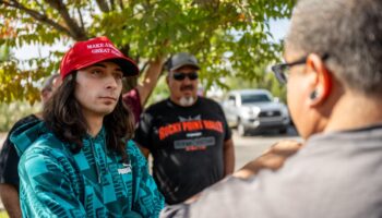 Suspect in Maga hat arrested after protester shot during demo against statue of conquistador in New Mexico