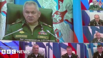 Still from footage shows video link with Defence Minister Sergey Shoygu on big screen and Adm Sokolov immediately below him
