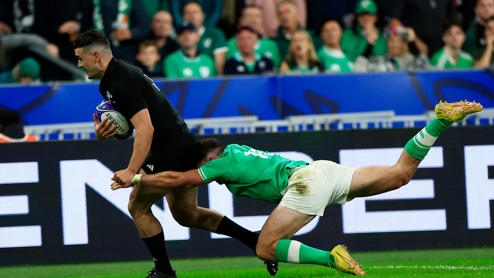 New Zealand's Will Jordan, left, scores a try as Ireland's Hugo Keenan tries to stop during the Rugby World Cup quarterfinal match between Ireland and New Zealand at the Stade de France in Saint-Denis, near Paris, Saturday, Oct. 14, 2023. (AP Photo/Aurelien Morissard)