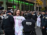 Pro-Palestinian protestors halt Macy's Thanksgiving parade and GLUE themselves to Sixth Avenue in NYC before being arrested - as New England Native American float sparks outrage by displaying Palestinian flag