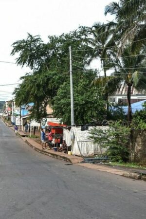 Two men walk Freetown's quiet streets during a curfew