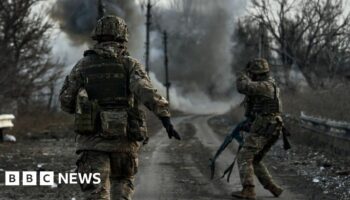 Ukrainian soldiers run in the Donbas region, February 2023