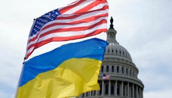 The American and Ukrainian flags wave in the wind outside of the Capitol on 23 April. Pic: AP Photo/Mariam Zuhaib
