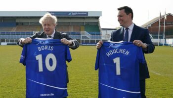 Jill Mortimer, Conservative party candidate for Hartlepool, Britain's Prime Minister Boris Johnson, and Ben Houchen, Tees Valley Mayor, from left, are presented with personalized Hartlepool United shirts in 2021. File pic: AP