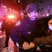 New York University protesters with flares clash with cops as desperate staff form human shield