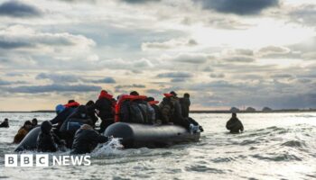 Migrants board a smuggler's boat in an attempt to cross the English Channel, on the beach of Gravelines, near Dunkirk, northern France on April 26, 2024