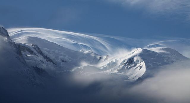 Breathtaking Snow-Capped Mount Etna Towering Over Sicily’s Sparkling Coastal Waters